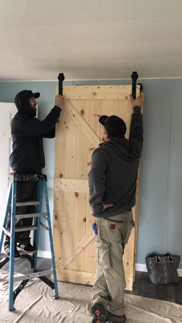 Handymen about to install a sliding door