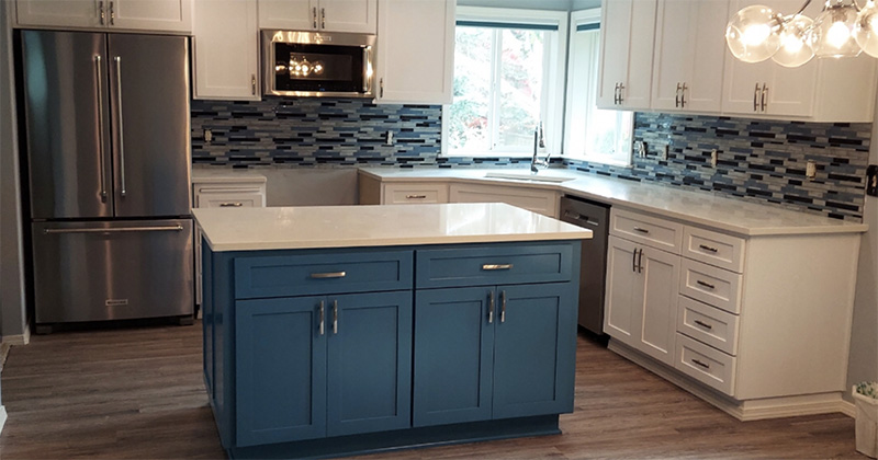 Kitchen with blue and white them, blue island and white marble countertops