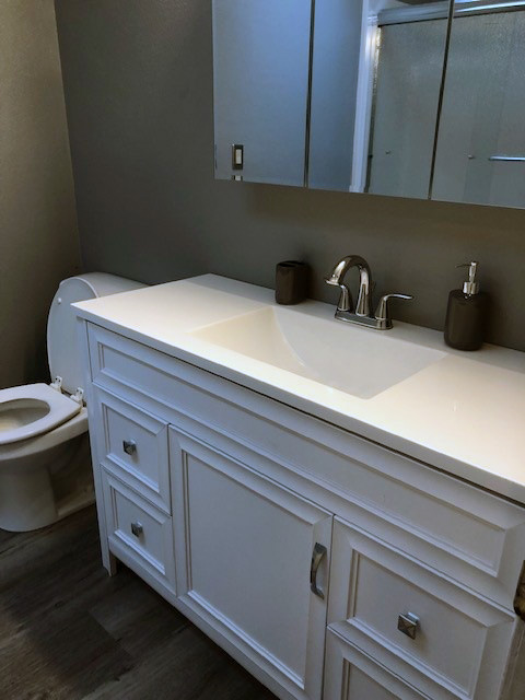 White sink and cabinets in bathroom