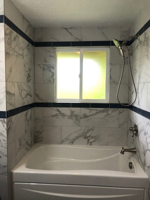 Marble tiled bath/shower with big tub