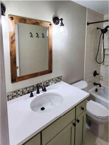 Renovated bathroom with sink and mirror