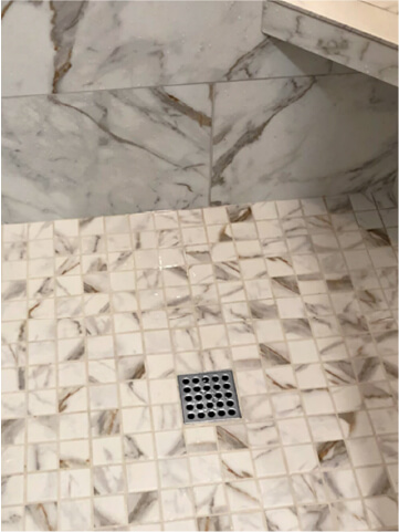 Renovated titled shower with square drain