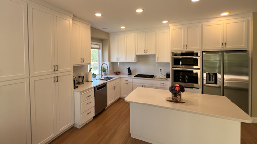 Kitchen with blue and white them, blue island and white marble countertops